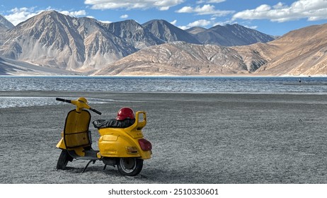 Zoomed in view of the yellow scooter parked on the lakeside - Powered by Shutterstock