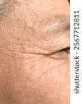 Zoomed-in profile of a middle-aged man. Wrinkles around the eyes.