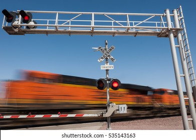 Zooming Train Engine Speeding Past Railroad Crossing