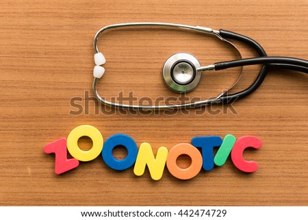 zoonotic colorful word with stethoscope on wooden background