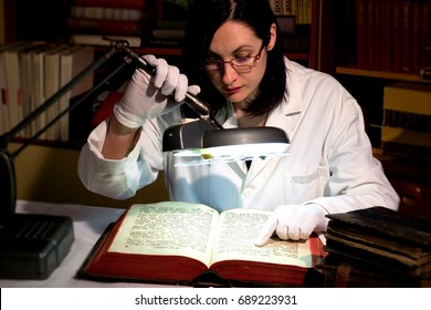 Zrenjanin,Serbia, 20th July 2017,Old Christian liturgical book,printed in Venice in 1765. Scientist studies the old Christian book using a large desktop magnifier, Old Church Slavonic Book,Photography