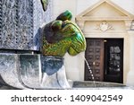 Zsolnay Fountain and the mosque in Pecs, Hungary.Secession style eosin fountain.It is made of pyrogranite, while the decorations are coated with a yellowish-green eosin layer