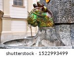 Zsolnay Fountain and the mosque in Pecs, Hungary.Secession style eosin fountain.It is made of pyrogranite, while the decorations are coated with a yellowish-green eosin layer