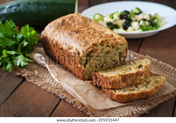 Zucchini bread\
with cheese on a wooden\
background