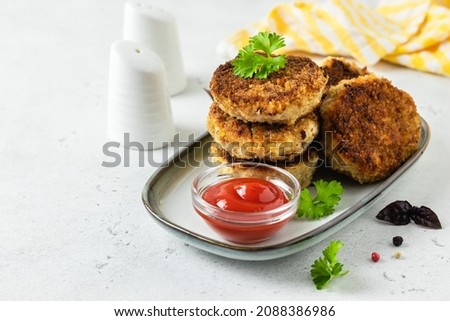 Zucchini chicken rissoles with ketchup. Space for text.