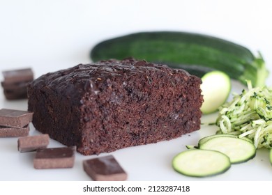 Zucchini chocolate cake. Moist double chocolate cake with grated zucchini, coco powder, chocolate and chocolate chips. Shot on white background