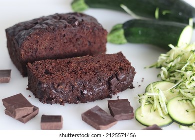 Zucchini chocolate cake slices. Moist double chocolate cake with grated zucchini, coco powder, chocolate and chocolate chips. Shot on white background
