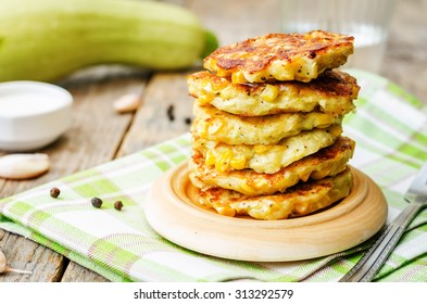 zucchini corn fritters on a dark wood background. the toning. selective focus