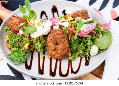 Zucchini And Halloumi Corn Fritters Featuring Caramalized Balsamic And Mint Ricotta Yoghurt With A Green Super Salad And A Light Pomegranate Dressing