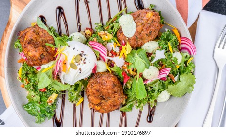 Zucchini And Halloumi Corn Fritters Featuring Caramalized Balsamic And Mint Ricotta Yoghurt With A Green Super Salad And A Light Pomegranate Dressing