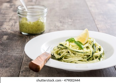 Zucchini Noodles With Pesto Sauce On Wooden Table