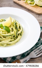 Zucchini Noodles With Pesto Sauce On Wooden Table

