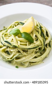 Zucchini Noodles With Pesto Sauce On Wooden Table