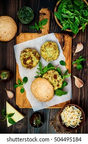 Zucchini Quinoa Veggie Burger With Pesto Sauce And Sprouts. Vegetarian Burger On A Cooking Sheet Ready To Prepare Hamburger. Top View, Overhead, Flat Lay