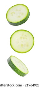 Zucchini, sliced round pieces, falling, hanging, flying, soaring, isolated on white background with clipping path.