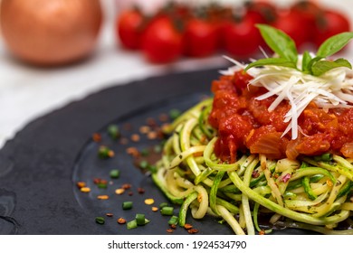 Zucchini spaghetti with dehydrated pepperoni, red sauce and grated Parmesan cheese