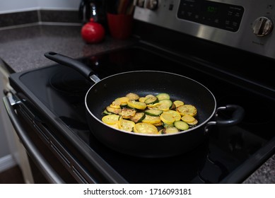 Zucchini And Squash Circles Being Fried Stove Top On A Skillet