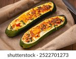 Zucchini stuffed with feta cheese, egg, parsley and cherry tomatoes