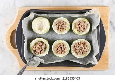 Zucchini stuffed with minced meat and rice, with tomatoes and mozzarella. Baked in the oven. Step-by-step cooking - Shutterstock ID 2195535403