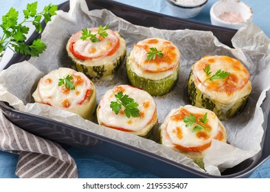 Zucchini stuffed with minced meat and rice, with tomatoes and mozzarella. Baked in the oven. - Shutterstock ID 2195535407