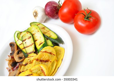 Zucchini And Yellow Summer Squash Grilled With Sauteed Mushrooms And Onions With Raw Tomatoes, Red Onion And Garlic On A White Background