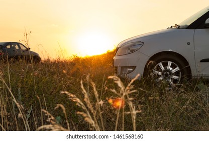 Zuevka/Ukraine - 07.21.2019: Side view of  two modern car parking on the meadow at sunset. Off-road travelling concept. - Shutterstock ID 1461568160