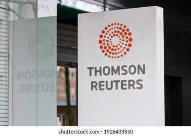 Zug, Switzerland - 26th February 2021 : Thomson Reuters sign hanging in front of the office entrance in Zug, Switzerland. Thomson Reuters is a Canada-based multinational media conglomerate