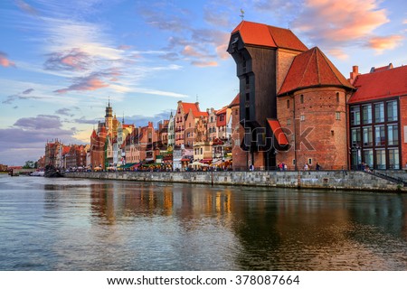 The Zuraw Crane and colorful gothic facades of the old town in Gdansk, Poland, on sunset