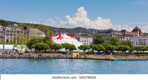 Zurich, Switzerland - 26 May, 2016: embankment of Lake Zurich, buildings of the city and a tent of the Circus Knie in the background. Lake Zurich is a lake extending southeast of the city of Zurich.