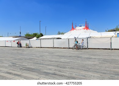 Zurich, Switzerland - 26 May, 2016: people at the fence of Circus Knie temporarily installed on Sechselautenplatz square. Circus Knie is the largest circus of Switzerland, based in Rapperswil.