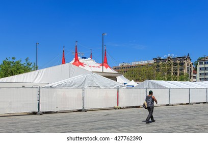 Zurich, Switzerland - 26 May, 2016: a person passing along the fence of Circus Knie temporarily installed on Sechselautenplatz square. Circus Knie is the largest circus of Switzerland.