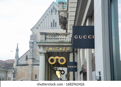 Zurich, Switzerland - August 2019: Logo sighn of Gucci and Zwicker stores on Poststrasse
