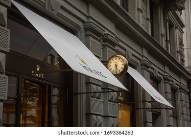 Zurich, Switzerland - August 2019: Rolex boutique shop golden door entrance view from Bahnhofstrasse