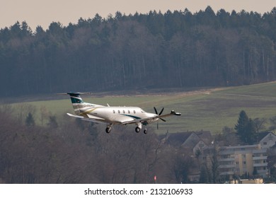 Zurich, Switzerland, February 24, 2022 Pilatus PC-12 propeller plane on its final approach on runway 14