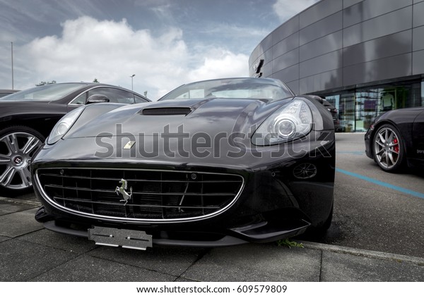 ZURICH, SWITZERLAND - JULY\
23, 2014: Luxury sports cars parked outside of car dealer showroom\
building