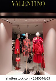 Zurich, Switzerland - June 26, 2019: Exterior entrance of Valentino boutique. Valentino store windows in Zurich. Showcase of a boutique of a famous fashion brand in the evening.
