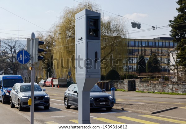 Zurich switzerland - march 10, 2021:Road traffic:\
speed and red light radar in one device, cars stop in the\
background, as traffic increases much more is controlled, image is\
focused on the radar