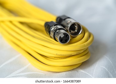 ZURICH, SWITZERLAND - MARCH 4, 2020: The photo shows a yellow microphone cable with a male and female xlr connector.