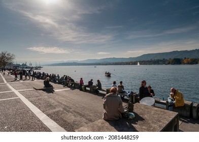 Zurich, Switzerland On October 20, 2012. Lake Zurich, People Sitting On The Sidewalk.