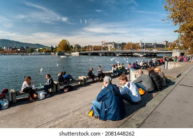 Zurich, Switzerland On October 20, 2012. Lake Zurich, People Sitting On The Sidewalk.