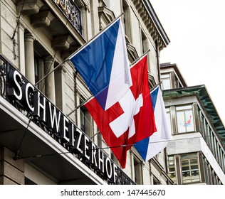 ZURICH-APRIL 21: Swiss And Zurich Flags In Front Of Hotel Schweizerhof In Zurich, Switzerland On April 21, 2012. Zurich Is Home To A Large Number Of Financial Institutions And Banking Giants.