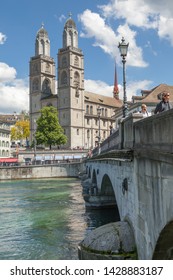 Zurich/Switzerland - May 30, 2019: Beautiful View On Limmat River With Great Minster Church (Grossmünster) And Münsterbrücke Of Zürich, Switzerland.