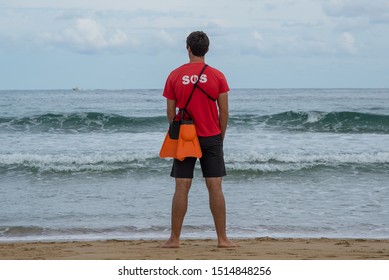 Zurriola Beach, Donastia-San Sebastian, Spain - September 9 2019: A Life Guard Keeps Watch, Looking Out To Sea