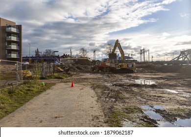 ZUTPHEN, NETHERLANDS - Dec 04, 2020: Empty Space With Heavy Machinery Working On A Lot Preparing The Soil And Location For Construction Of Residential Apartment Building At Kade Zuid