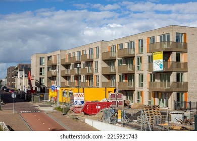 Zutphen, The Netherlands - October 2022: Construction Company Containers In Street With Newly Build Apartment Complex Ubuntuplein