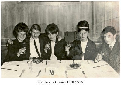 ZVOLEN, CZECHOSLOVAK REPUBLIC, CIRCA 1967 - Group of friends, at a table in a restaurant - circa 1967