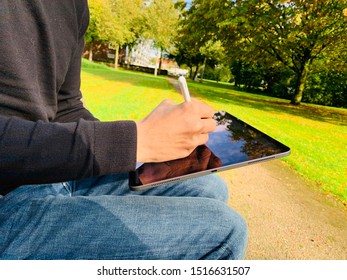 Zwolle, Nederland - September 28, 2019, Apple Product Photographed Outside. IPhone, EarPods, IPad Pro In A Park In Holland.