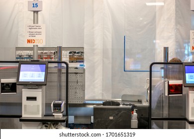 Zwolle, Netherlands - 04 12 2020: Protective Plastic And Plexiglass Screen Shields Installed At The Tills In Supermarket To Stop Coronavirus Spread. Cash Desks With Protective Shields. 