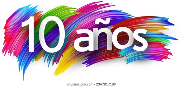 10 years at spanish paper word sign with colorful spectrum paint brush strokes over white. Vector illustration.