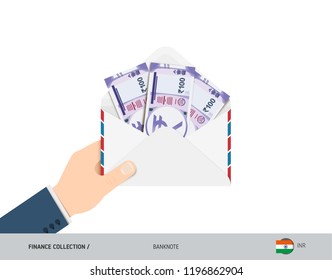 100 Indian Rupee Banknotes in envelope hold in hand. Flat style opened white envelope with cash. Salary payout or corruption concept.